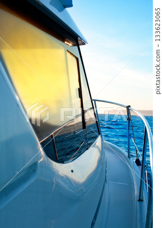 blue golden sunrise sailing on boat side 133623065