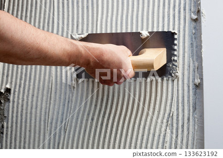 construction notched trowel with white cement construction notched trowel with white cement 133623192