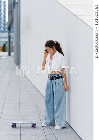 Gen Alpha Girl Holding Skateboard And Smiling 133623363