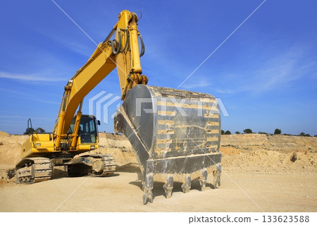 excavator yellow vehicle sand quarry outdoor blue sky excavator yellow vehicle sand quarry outdoor blue sky 133623588