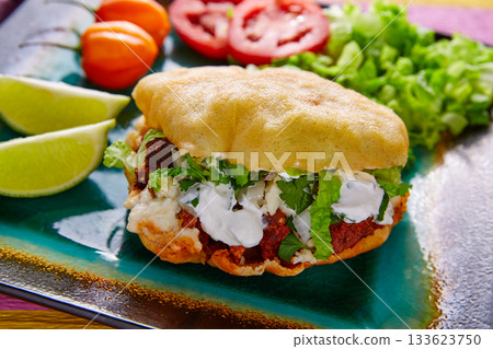 Gordita mexican taco filled with pastor meat Gordita mexican taco filled with pastor meat 133623750