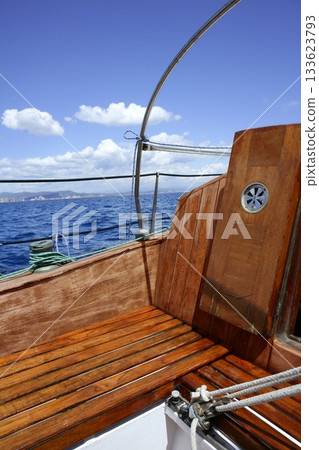 wooden sailboat boat deck blue sky ocean sea 133623793
