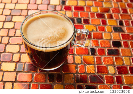 Coffee glass cup with cream on tiles red table Coffee glass cup with cream on tiles red table 133623908