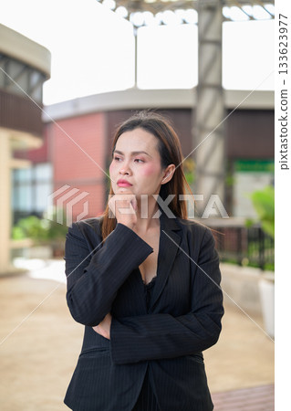 Thai Business Woman Outdoors in Professional Attire Thinking with Hand on Chin 133623977