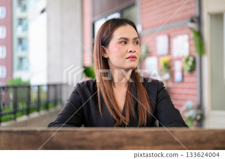 Thai Business Woman Outdoors in Professional Attire Thai Business Woman Outdoors in Professional Attire 133624004