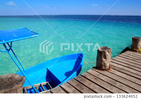 blue boat in wooden tropical pier in Caribbean blue boat in wooden tropical pier in Caribbean 133624052