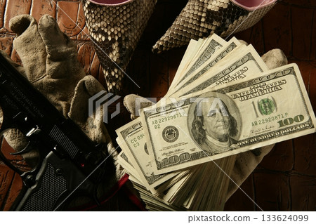 Dollar notes and gun, black pistol 133624099