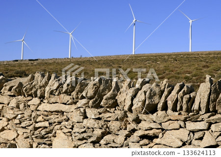 Electric windmills with a masonry rural wall 133624113