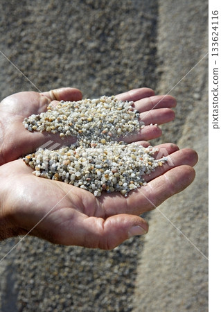 gravel sand in man hands in quarry showing camera 133624116