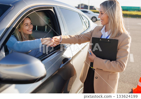 Instructor Congratulating Learner Driver after Practical Driving Exam 133624199