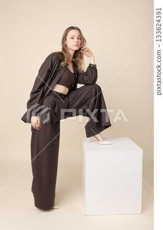 Beautiful woman with brown linen suit studio portrait 133624391