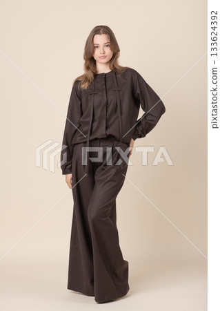 Beautiful woman with brown linen suit studio portrait 133624392