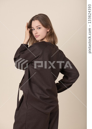 Beautiful woman with brown linen suit studio portrait 133624393