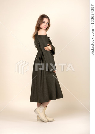 Beautiful woman with green or khaki linen dress studio portrait Beautiful woman with green or khaki linen dress studio portrait 133624397