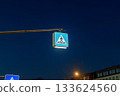 traffic light with a yellow road sign 133624560