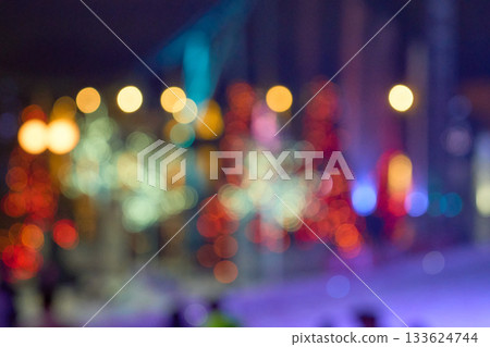 Defocused red, teal, and gold circles shimmer against a dark night scene. A vibrant bokeh field makes a rich, festive background. Defocused red, teal, and gold circles shimmer against a dark night scene. A vibrant bokeh field makes a rich, festive background. 133624744
