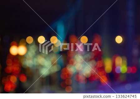 Defocused city lights create a colorful bokeh background. Warm and cool circles glow with a festive holiday atmosphere. Defocused city lights create a colorful bokeh background. Warm and cool circles glow with a festive holiday atmosphere. 133624745