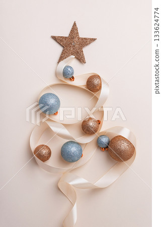 Minimalist Christmas Tree Made of Ribbon and Ornaments on Light Background Minimalist Christmas Tree Made of Ribbon and Ornaments on Light Background 133624774