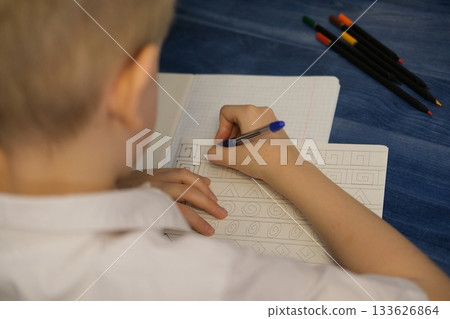 Child tracing patterns in notebook learning new skills Child tracing patterns in notebook learning new skills 133626864