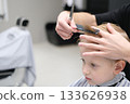 Child receiving haircut in barbershop, fresh style 133626938