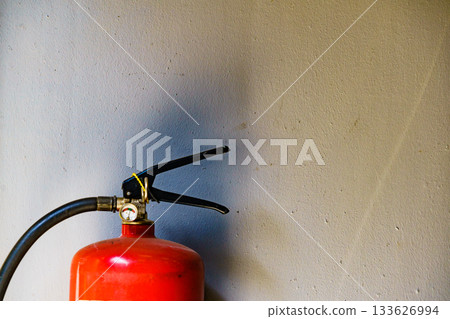 Fire extinguisher agains wall 133626994
