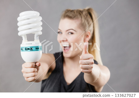 Woman holding eco modern light bulb 133627027