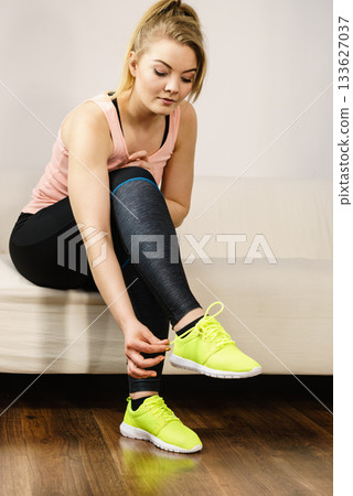 Woman putting sport shoes Woman putting sport shoes 133627037