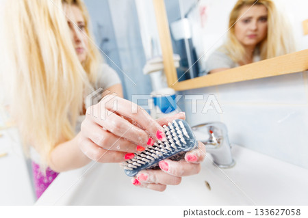 Female washing her hands, using soap brush 133627058
