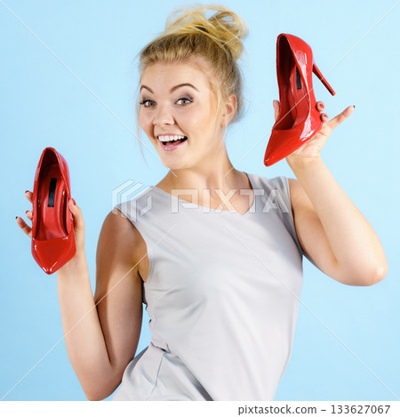 Fashion stylist presenting high heels Fashion stylist presenting high heels 133627067