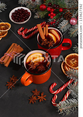 Strong alcoholic or non-alcoholic cocktail in iron mugs, mulled wine with spices, star anise, cranberries, orange, apple and cinnamon, warming winter drink in the cold season, Christmas festive grog, Strong alcoholic or non-alcoholic cocktail in iron mugs, mulled wine with spices, star anise, cranberries, orange, apple and cinnamon, warming winter drink in the cold season, Christmas festive grog, 133627392