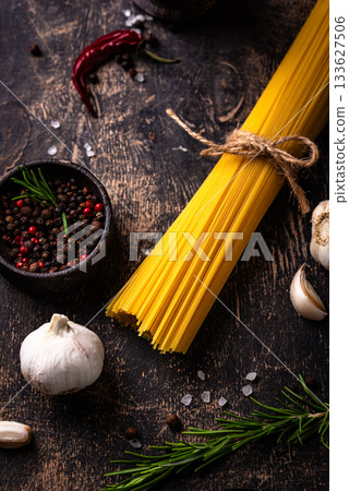 Italian food background with spaghetti, tomato and spices Italian food background with spaghetti, tomato and spices 133627506