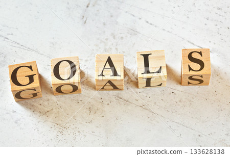 Five wooden cubes with word GOALS on white stone like board, view from above Five wooden cubes with word GOALS on white stone like board, view from above 133628138