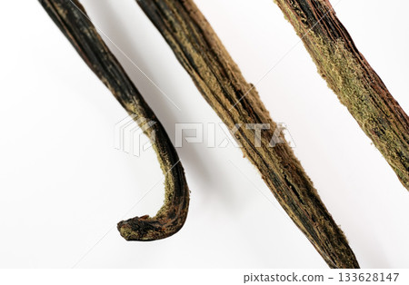White / yellow mould or mildew growing on vanilla sticks stored improperly in wet and cold fridge - close up detail photo isolated on white background 133628147