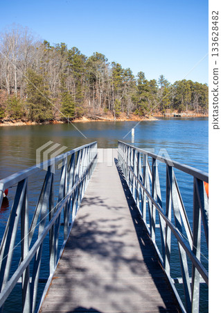 A bridge over a body of water with trees in the background 133628482