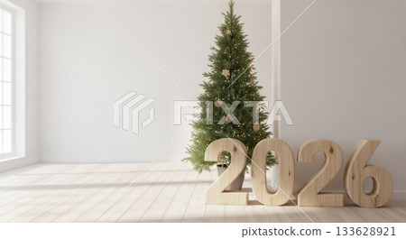 A minimalist room features a decorated Christmas tree and large wooden numbers spelling out 2026, bathed in natural light from a window 133628921