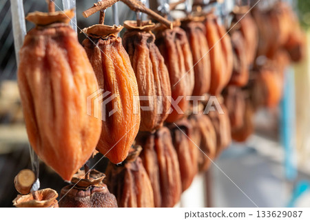 Dried persimmons being dried in the sun Dried persimmons being dried in the sun 133629087