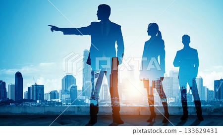 A business partner leader pointing the way in an urban office in the morning and evening sun, and the future chosen by the employees who follow 133629431
