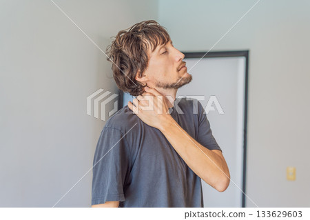 Man holding his neck in discomfort, experiencing tension and pain, concept of muscle strain, posture issues, stress, health awareness and physical well-being Man holding his neck in discomfort, experiencing tension and pain, concept of muscle strain, posture issues, stress, health awareness and physical well-being 133629603