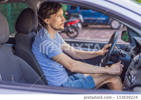 Man parking his car in an urban setting, carefully maneuvering in a tight space. Concept of driving, vehicle control, daily commute, safe parking, and modern lifestyle 133630224