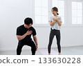 Young woman receiving training from a personal trainer Young woman receiving training from a personal trainer 133630228