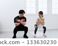 Young woman receiving training from a personal trainer Young woman receiving training from a personal trainer 133630230
