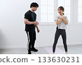 Young woman receiving training from a personal trainer Young woman receiving training from a personal trainer 133630231