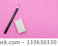 A black pencil and a white eraser on a bright pink background 133630330
