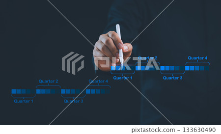 Business hand planning quarterly timeline with digital chart, representing project management, strategy, scheduling, corporate goals, and financial planning for effective business growth. 133630490