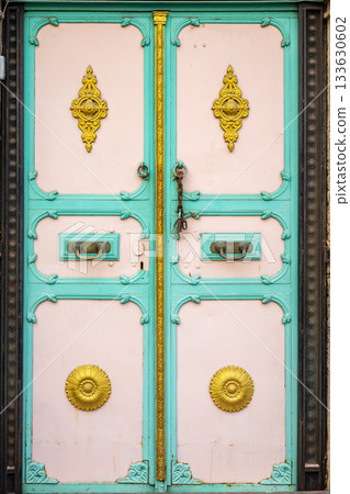 Ornate teal and pink vintage door with gold accents and intricate design Ornate teal and pink vintage door with gold accents and intricate design 133630602