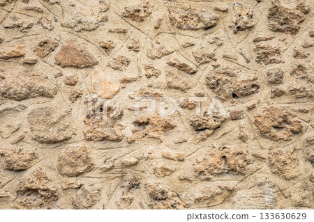 Rough stone wall texture with weathered surface and uneven stones 133630629