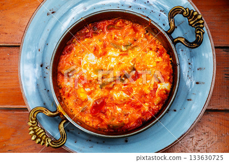 Traditional turkish menemen in copper pan with tomatoes and peppers 133630725