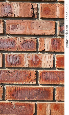 Close-Up Of Red Brick Wall Texture With Weathered Surfaces and Rugged Character 133630988