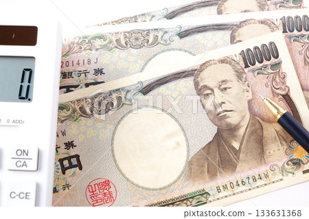 Ten thousand yen bills and a calculator on the table 133631368