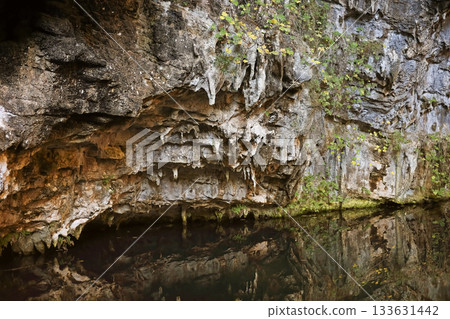 Rocky cave wall with water reflection 133631442
